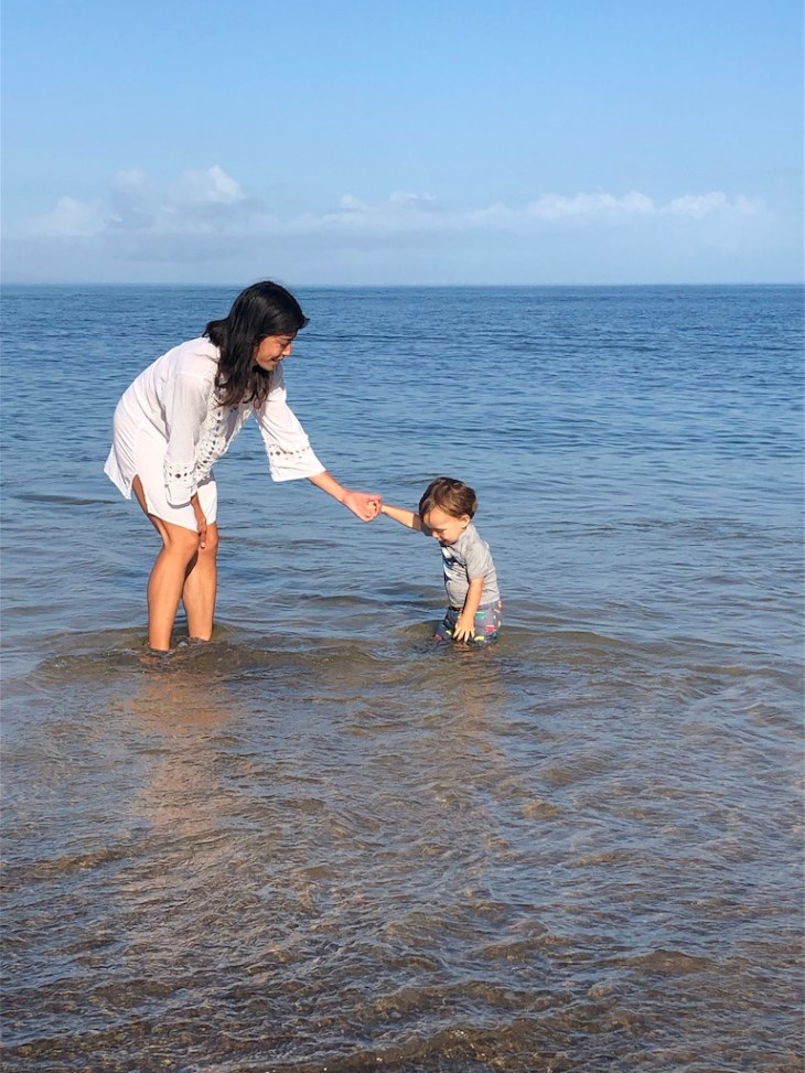 Mother and son in the ocean together.