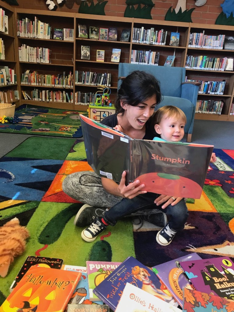 mother reading Stumpkin book to her toddler boy at the local library
