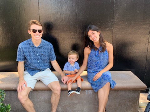 Father and father sitting next to son